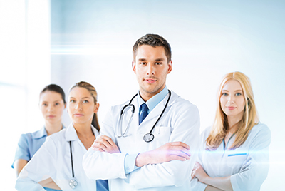 four doctors standing with arms crossed